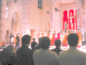 Beyond the Holy Name Society men in the front pews, Fr. McMahon kneels on the side leading the Rosary while the monks continue to be dazed. Don't they get it? Get off the altar and out of the basilica!