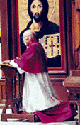 File photo of Archbishop Sheehan kneeling in prayer at the side of the altar at St. Cecilia's - photo from Archdiocese
