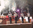 Military personel from several nations hold aloft incense during Benediction at St. Pius X Basilica